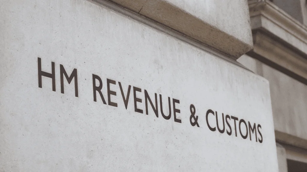 Hm revenue & customs sign on a building indicating VAT Return Filing procedures and potential penalties for non-compliance.