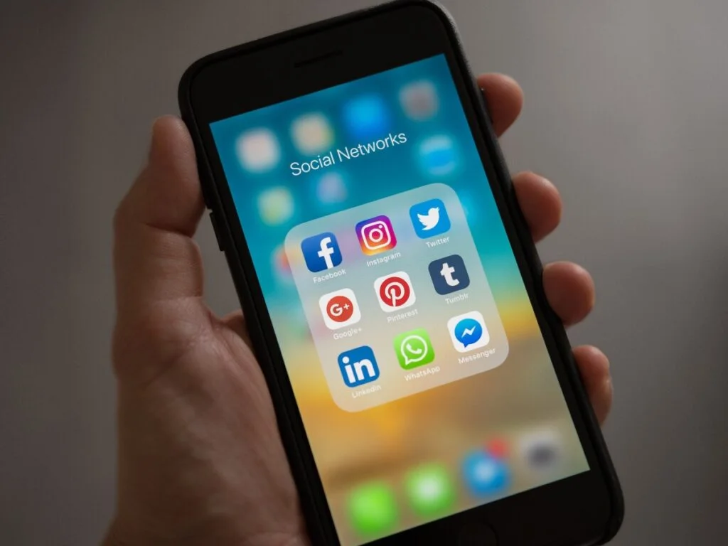 Tax Guide for Content Creators and Social Media Influencers 1 Social media icons on phone