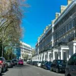Cars parked on a street in London, incorporating tax benefits.