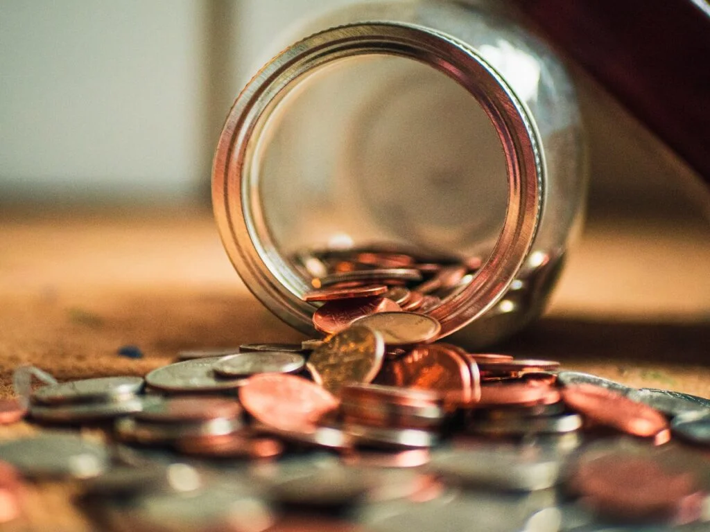 Jar with money pouring out