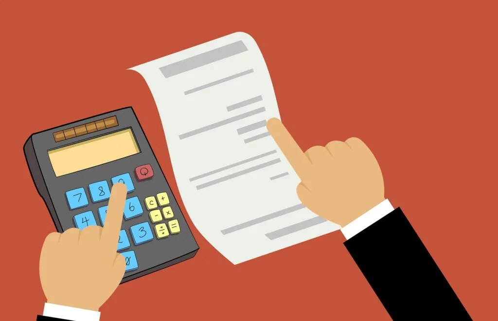 A hand holding a calculator and a piece of paper, guiding through tax returns.