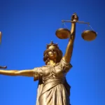 A statue of justice holding a sword and scales, symbolizing fairness and equity.