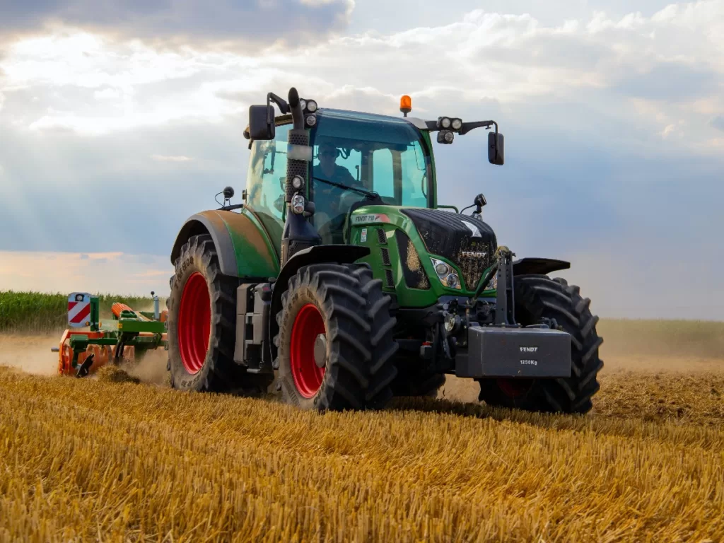 Tractor driving on crop field