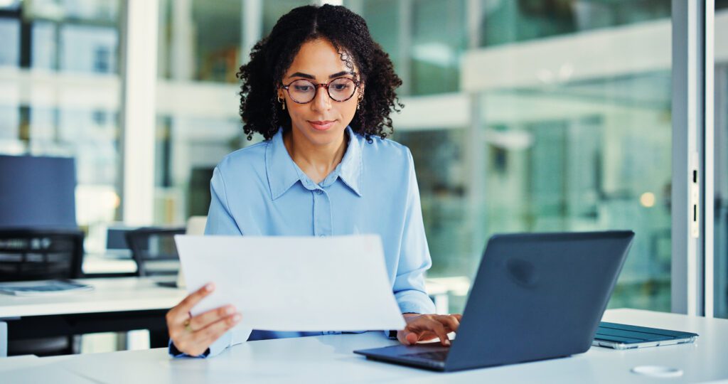 Documents, laptop and businesswoman in office with research for finance report with budget plan. Computer, reading and female financial manager with paperwork for investment proposal in workplace