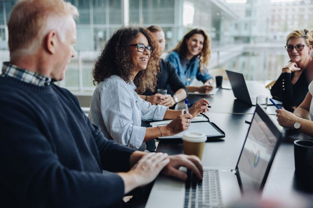 October 2026 Newsletter 5 Multi-ethnic business people smiling during a meeting in conference room. Team of professionals having meeting in boardroom.