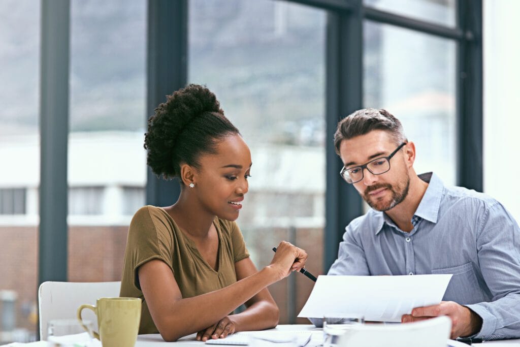 Cropped shot of two colleagues having a meeting in an office.