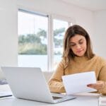 Are You Ready for Making Tax Digital (MTD)? 12 Person reading documents at desk.