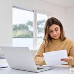 Are You Ready for Making Tax Digital (MTD)? 14 Person reading documents at desk.