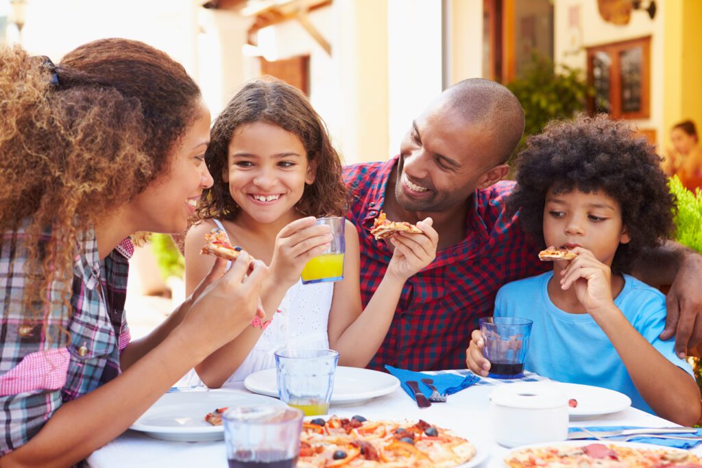 July 2026 Newsletter 4 Family Eating Meal At Outdoor Restaurant Together