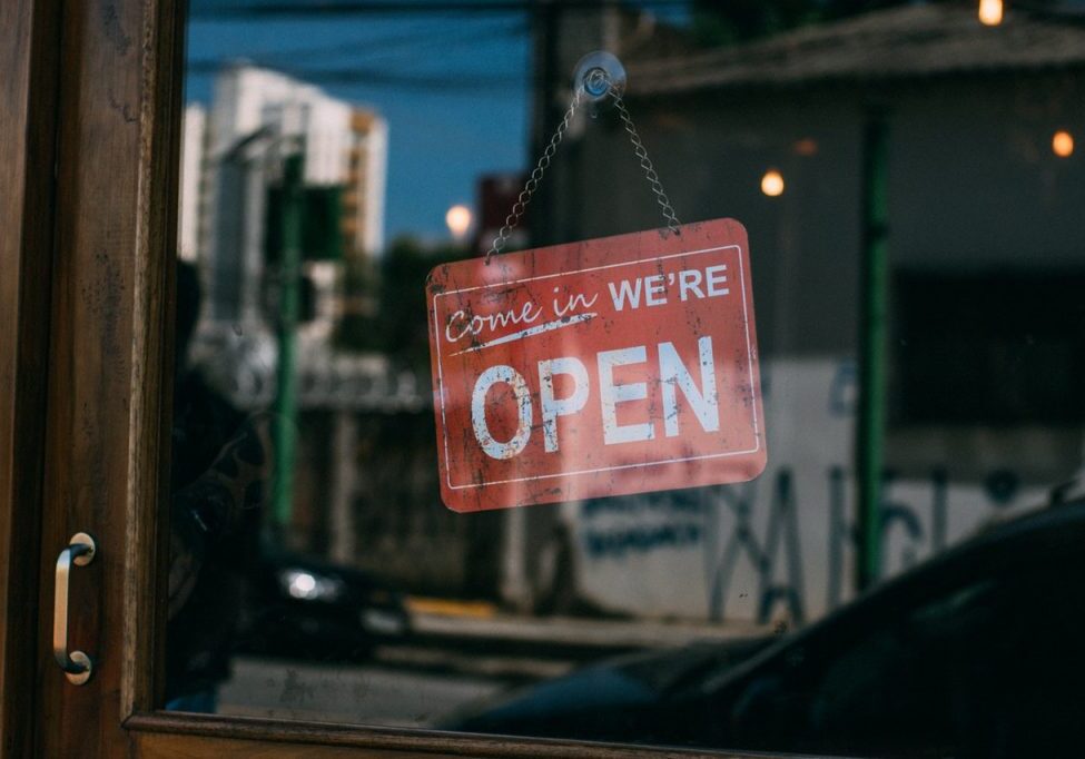 A small business accountant sign hanging from a window.
