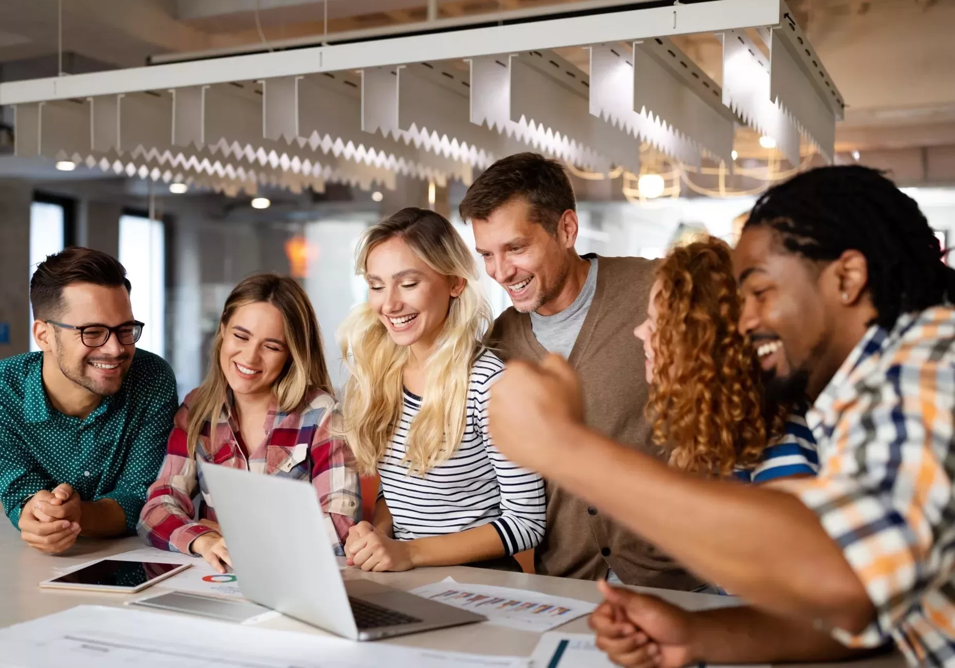 A group of Start-Up Accountants sitting around a table looking at a laptop.
