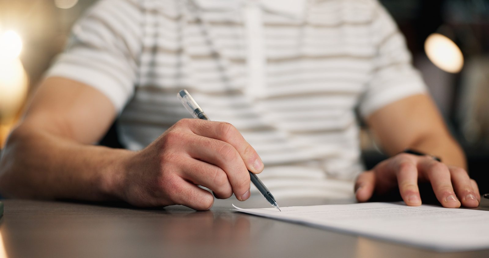Property Incorporation Report 1 Businessman signing contract documents in an office