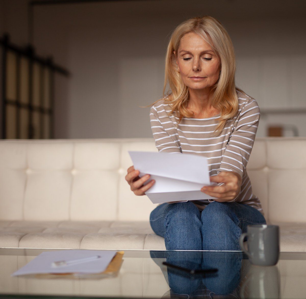 Voluntary Disclosure to HMRC 1 Mature woman reading a letter at home